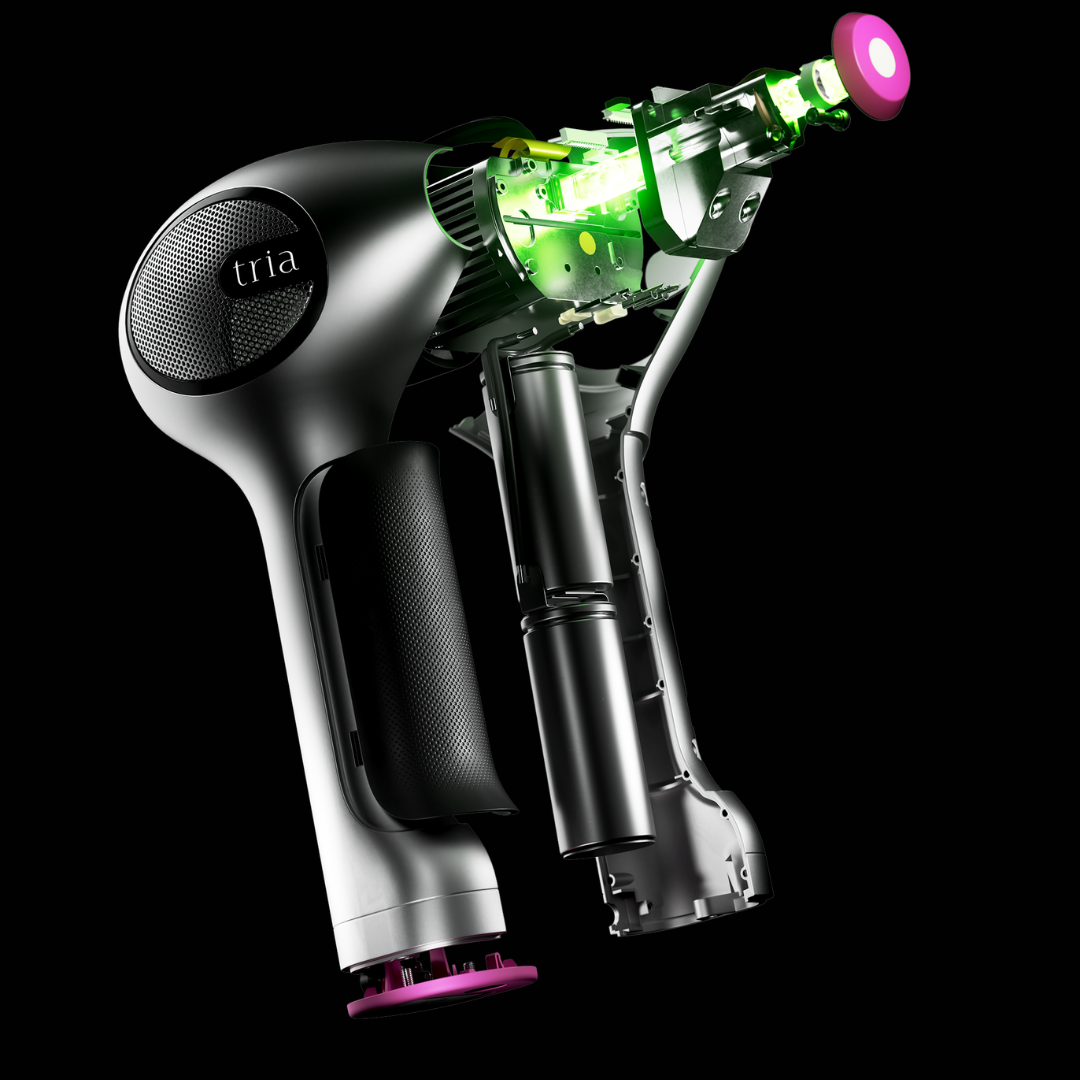 Close-up of a Tria 4X hair removal laser device on a black background